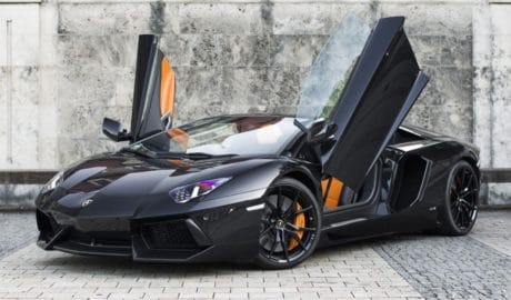 A Lamborghini Aventador Roadster with open doors.