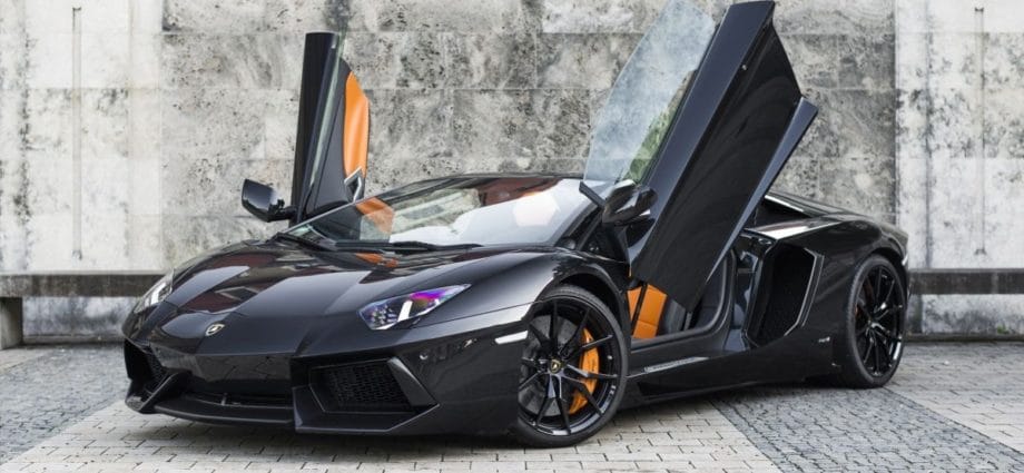 A Lamborghini Aventador Roadster with open doors.