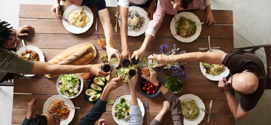 People sitting at a dinning table having a prepared dinner together.