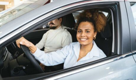 A smiling woman inside a car. How Preventive Maintenance Leads to Safer Driving - Newslibre