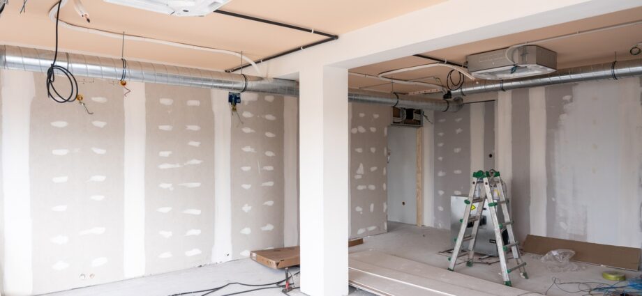 How Proper Planning Keeps Commercial Renovations on Schedule 1 A large room in the middle of being renovated. There is finished drywall and an HVAC system visible.